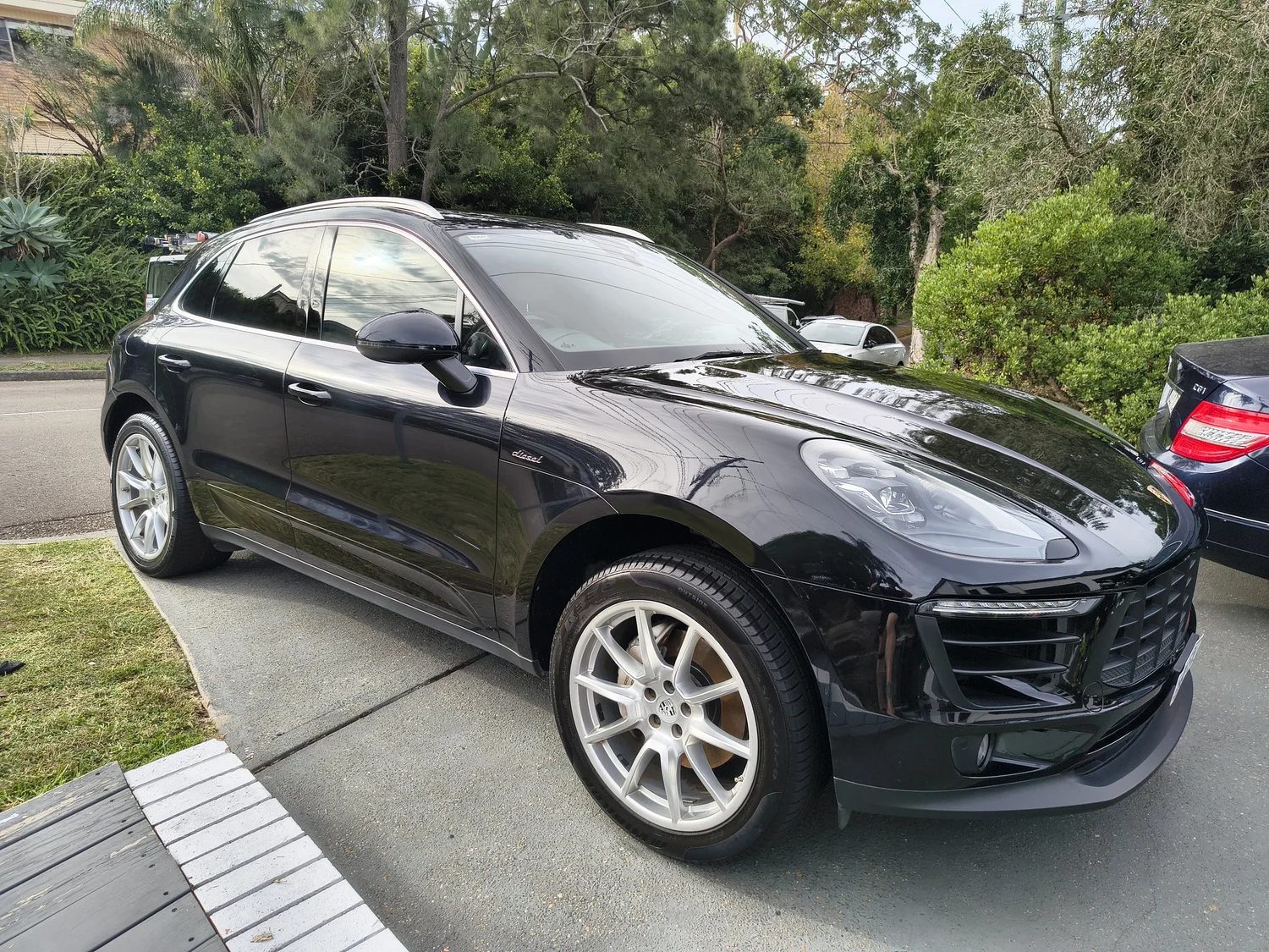 Freshly washed black Porsche detailed at a Sutherland Shire home