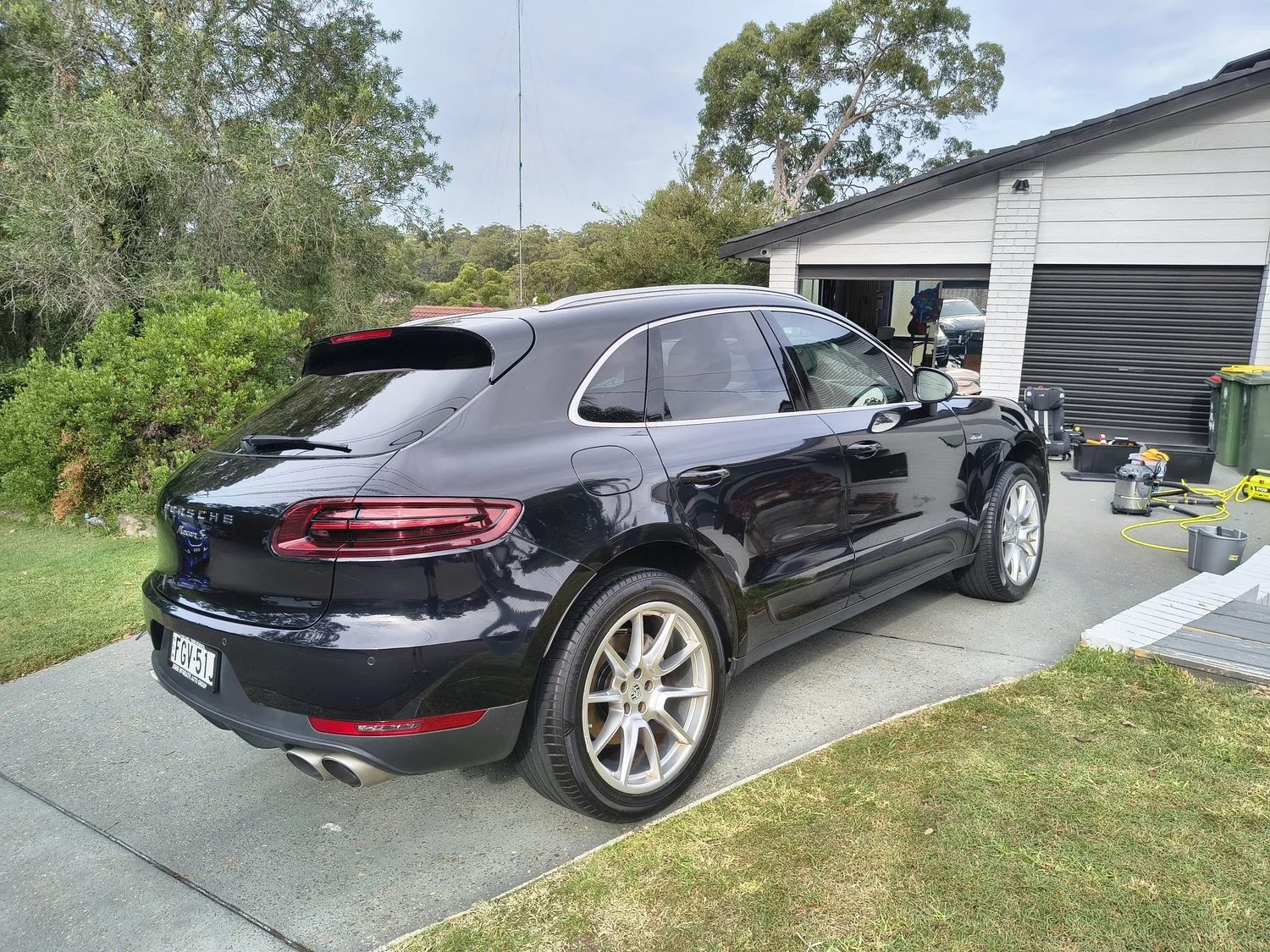 Black SUV being professionally detailed in a home driveway in the Sutherland Shire